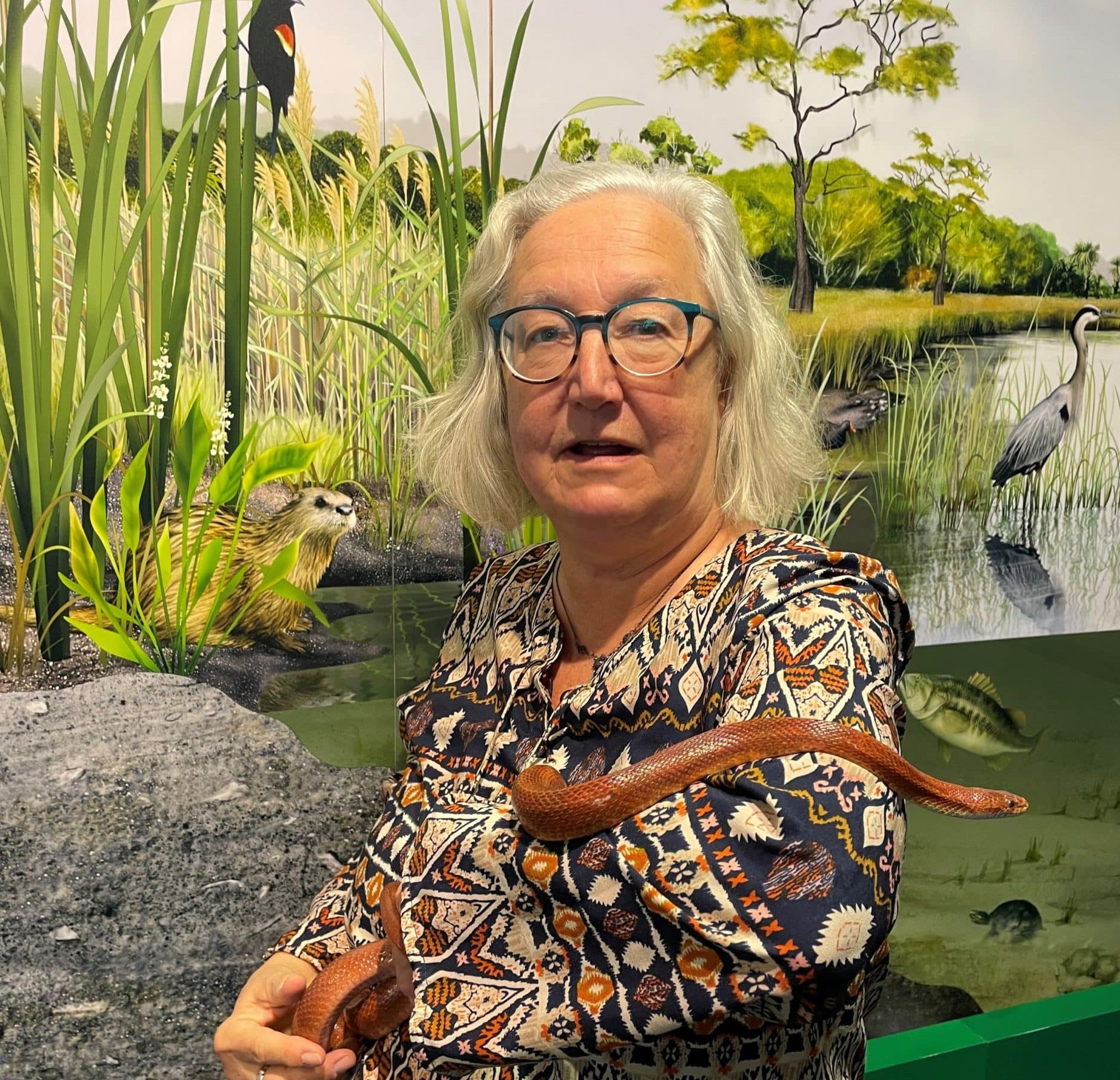 Nature Center volunteer Kathy McKendree with resident rat snake "Penny".